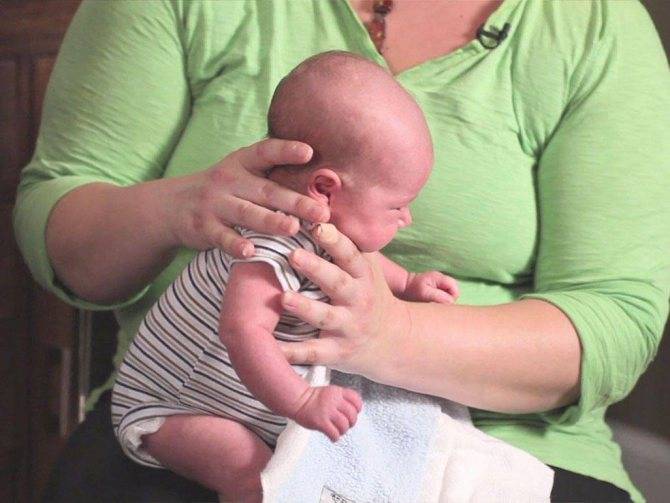 Как правильно держать новорожденного ребенка столбиком, при подмывании (фото)